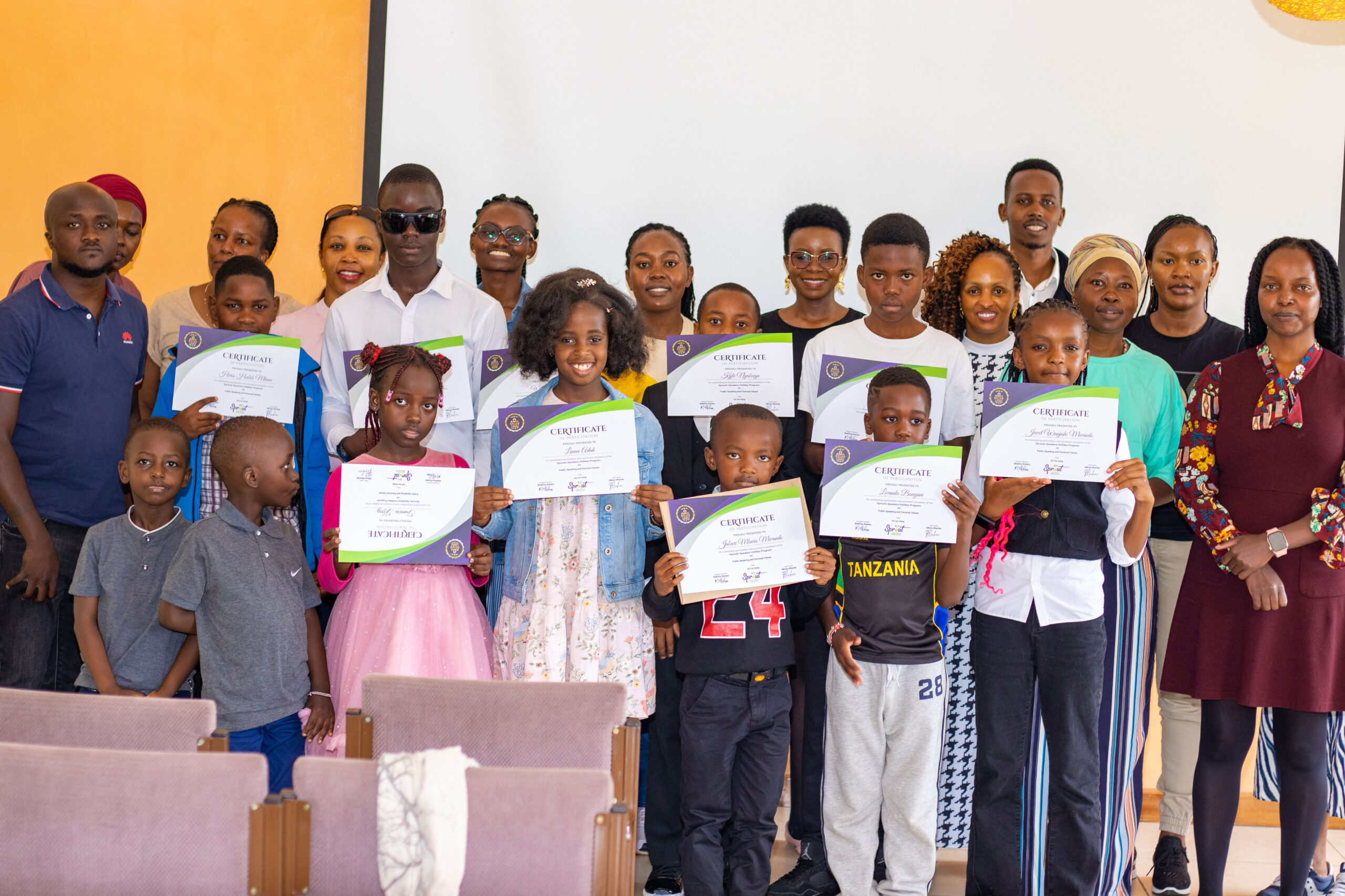Kids holding certificates at a Sprout Life Skills graduation in Nairobi