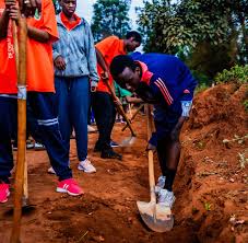 Community members working together on a shared public space in Africa, reflecting the spirit of Umuganda