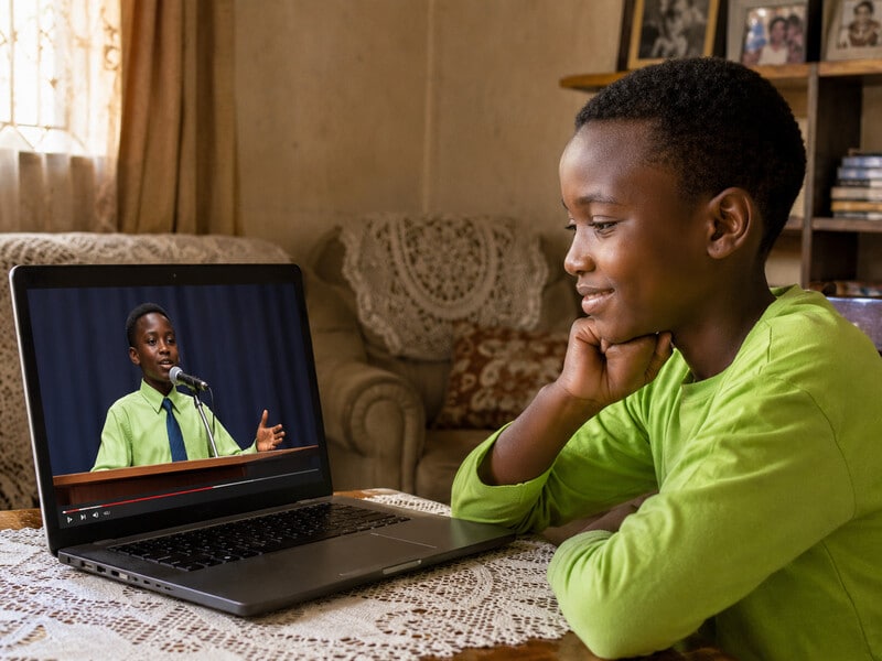 A child watching their own speech live on the championship site